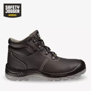 A side-by-side view of a black Safety Jogger BestBoy high-ankle boot, showing its rugged leather upper and its specialized PU/PU slip-resistant tread pattern for industrial safety.